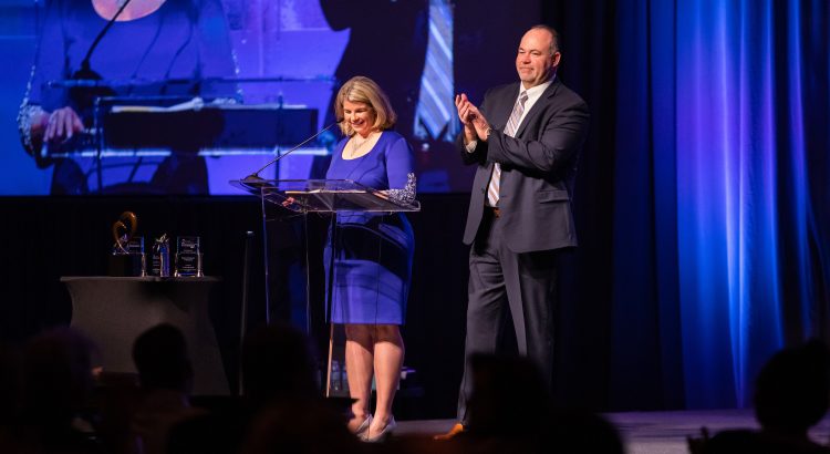 Mongonia and Templeton announcing Presidents' Circle winners on stage